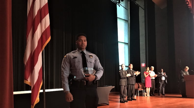Dayton police officer Byron Branch holds his Officer of the Year Award. CORNELIUS FROLIK / STAFF