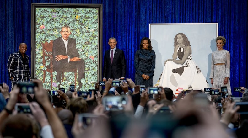 From left, artist Kehinde Wiley, who painted former President Barack Obama’s portrait, former President Barack Obama, former first lady Michelle Obama, and artist Amy Sherald, who painted Michelle Obama’s portrait, stand on stage together during an unveiling ceremony at the Smithsonian’s National Portrait Gallery, Monday, Feb. 12, 2018, in Washington. (AP Photo/Andrew Harnik)