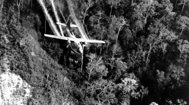 In this May 1966 file photo, a U.S. Air Force C-123 flies low along a South Vietnamese highway spraying defoliants on dense jungle growth beside the road to eliminate ambush sites for the Viet Cong during the Vietnam War. Because of concerns about Agent Orange, more than one-quarter of the 1 million Vietnam veterans receiving disability checks are getting compensation for diabetes and other common ailments of age, with erectile dysfunction among them, according to millions of VA claims records obtained by The Associated Press through the Freedom of Information Act. (AP Photo/Department of Defense, File)