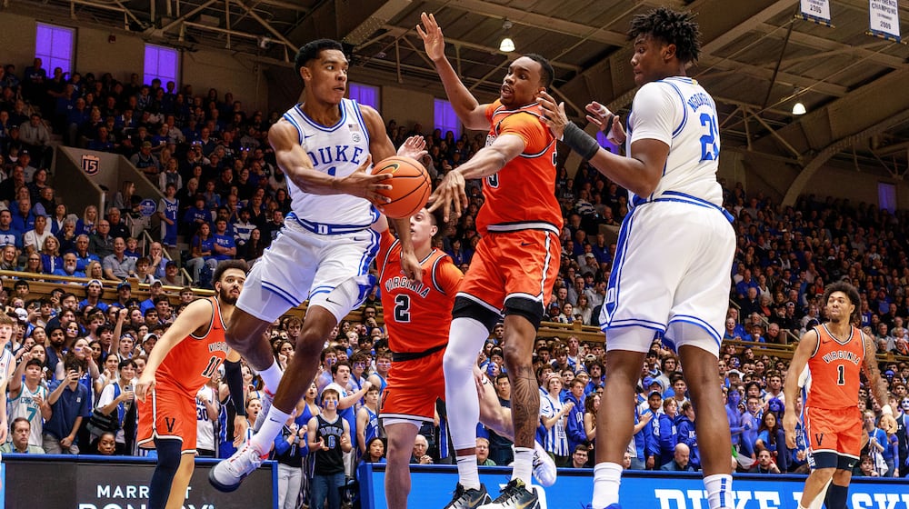 Duke's Caleb Foster (1) passes to Patrick Ngongba II (21) as Virginia's Chance Mallory (2) and Ugonna Onyenso, middle, defend during the second half of an NCAA college basketball game in Durham, N.C., Saturday, Feb. 28, 2026. (AP Photo/Ben McKeown)