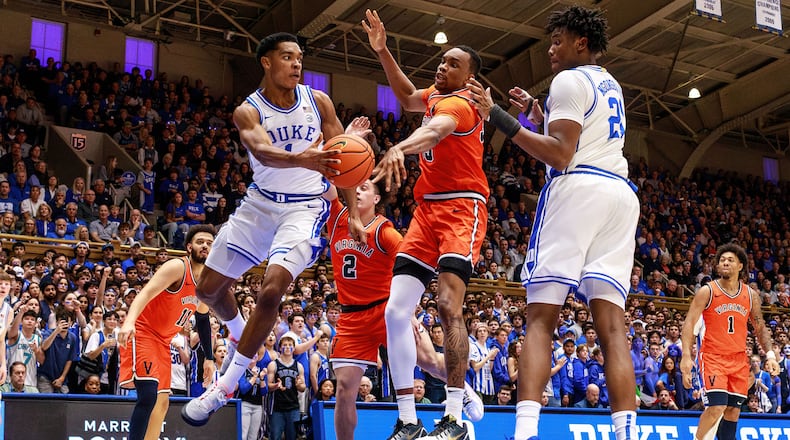 Duke's Caleb Foster (1) passes to Patrick Ngongba II (21) as Virginia's Chance Mallory (2) and Ugonna Onyenso, middle, defend during the second half of an NCAA college basketball game in Durham, N.C., Saturday, Feb. 28, 2026. (AP Photo/Ben McKeown)