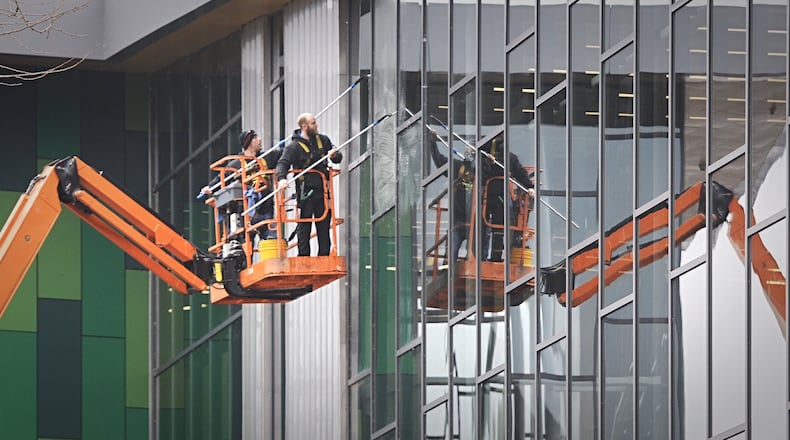 The reflection of the glass at the downtown Dayton Metro Library has the appearance of the windows being cleaned inside and out. MARSHALL GORBY / STAFF