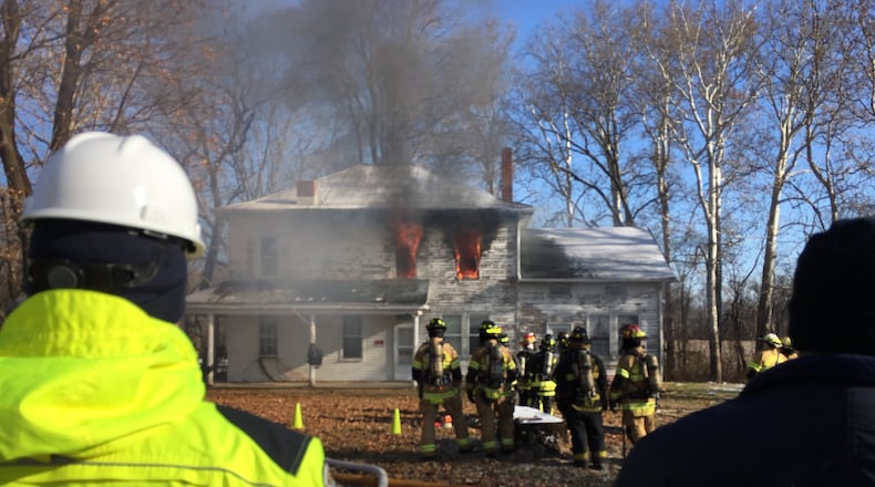 UL Firefighter Safety Research Institute and the Illinois Fire Service Institute conducted research during live fires at abandoned homes this week at homes in Beavercreek Twp. RICHARD WILSON/STAFF