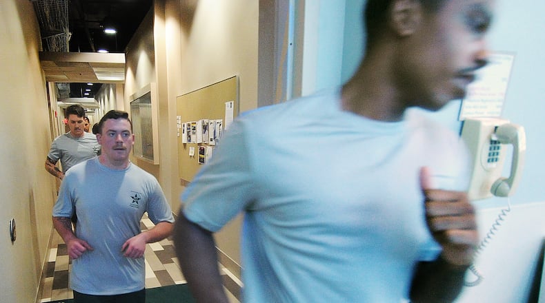 Police cadets run a circuit through the halls at Sinclair Community College, Thursday, Jan. 11, 2024. MARSHALL GORBY\STAFF