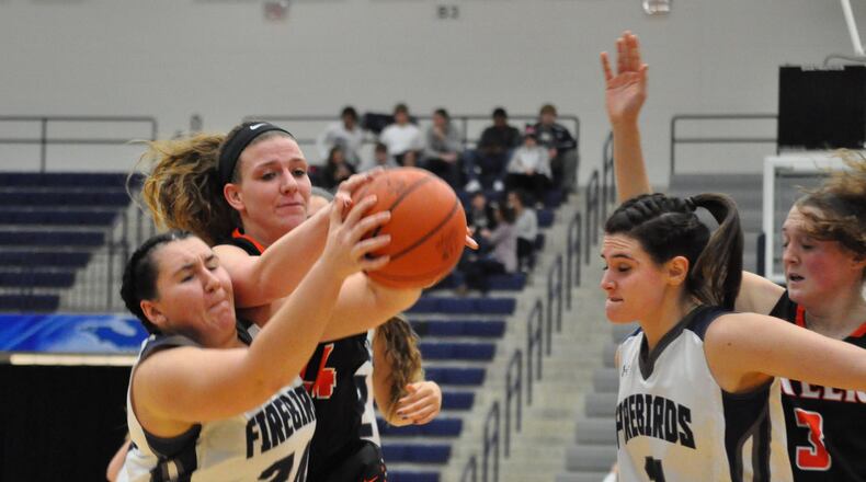 Beavercreek forward Lexi Moore (middle) battles with Fairmont forward Avery Alberts for a loose ball during the Beavers’ 50-39 defeat of the Firebirds at Trent Arena last month. NICK DUDUKOVICH / CONTRIBUTED