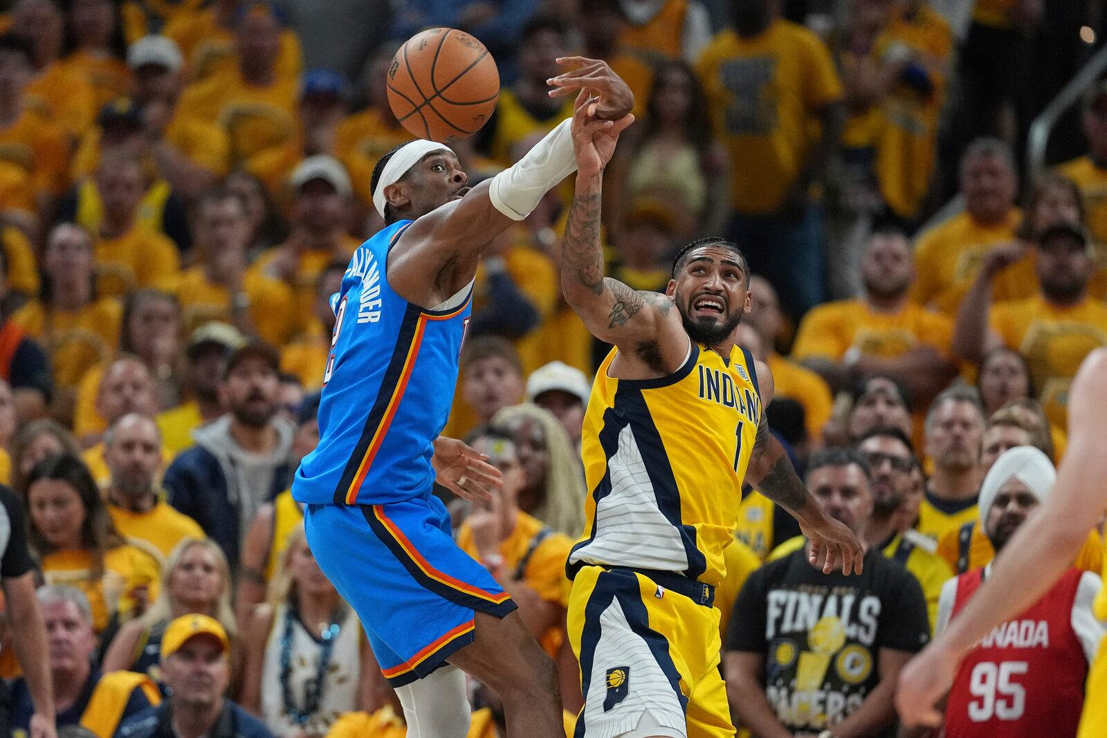 Oklahoma City Thunder guard Shai Gilgeous-Alexander (2) and Indiana Pacers forward Obi Toppin (1) battle for the ball during the second half of Game 4 of the NBA Finals basketball series, Friday, June 13, 2025, in Indianapolis. (AP Photo/Michael Conroy)