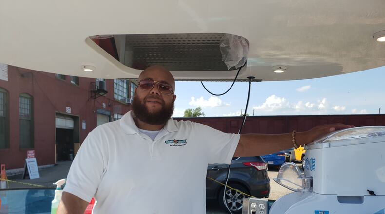 Greg Young of Snowie Dayton took a break from handing out his popular shaved ice creations.