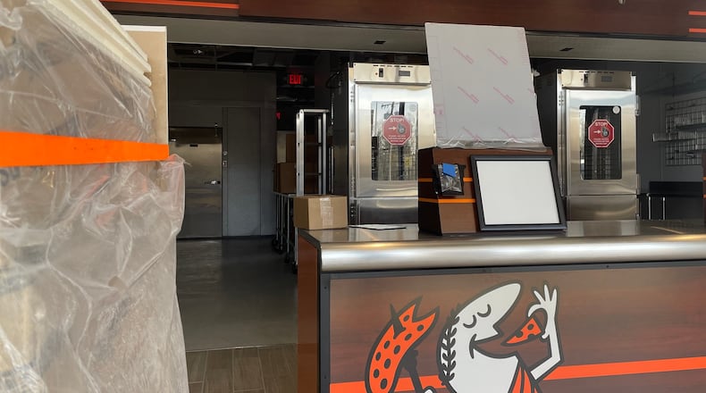 Construction is underway on a new Little Caesars carryout location in the Dixie Square Shopping Center in Harrison Twp. after the pervious store was destroyed in the 2019 Memorial Day tornadoes. NATALIE JONES/STAFF
