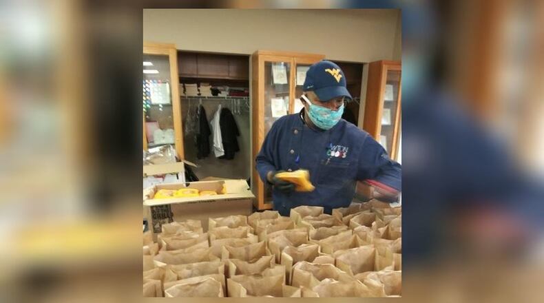Executive Chef, Chef Thomas, from Dayton Cooks putting together the grab and go meals the organization has been providing daily for children. CONTRIBUTED