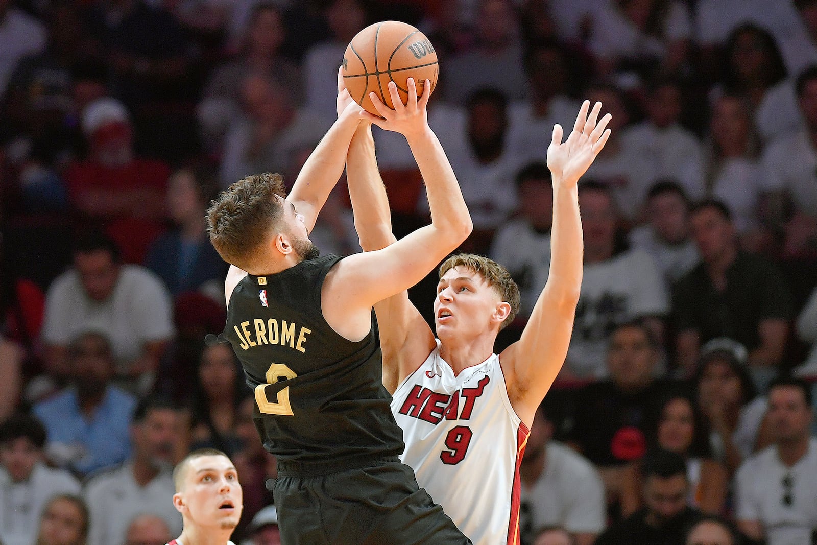 Cleveland Cavaliers guard Ty Jerome (2) shoots over Miami Heat guard Pelle Larsson (9) during the first half in Game 3 of an NBA basketball first-round playoff series, Saturday, April 26, 2025, in Miami. (AP Photo/Michael Laughlin)