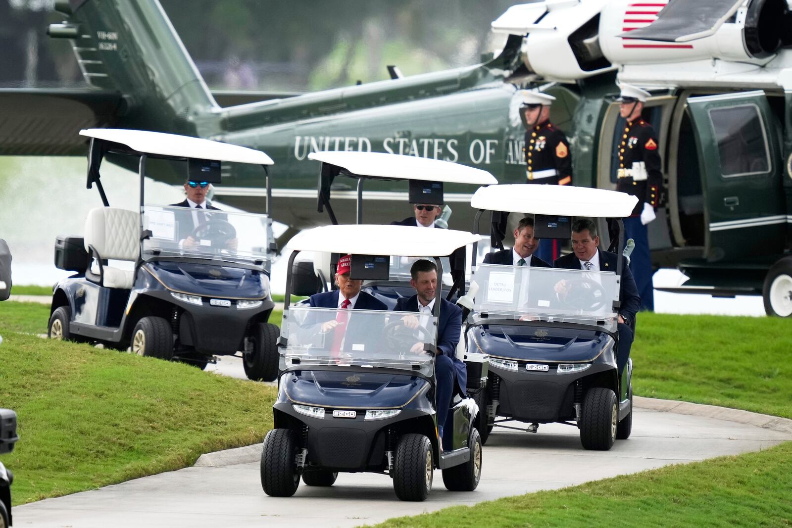 President Donald Trump, driven by his son Eric Trump, arrives at Trump National Doral during the LIV Golf Miami tournament, Thursday, April 3, 2025, in Miami. (AP Photo/Alex Brandon)