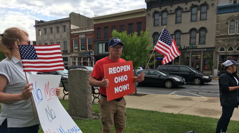 A small group of demonstrators gathered Saturday, June 13, outside the Greene County Courthouse in Xenia to rally for a return to school in the fall without restrictions. This is one of a series of rallies happening across the state. THOMAS GNAU/STAFF