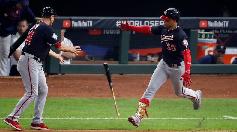 *** BESTPIX *** HOUSTON, TEXAS - OCTOBER 29: Juan Soto #22 of the Washington Nationals tosses the bat toward first base coach Tim Bogar #24 after hitting a solo home run against the Houston Astros during the fifth inning in Game Six of the 2019 World Series at Minute Maid Park on October 29, 2019 in Houston, Texas. (Photo by Tim Warner/Getty Images)