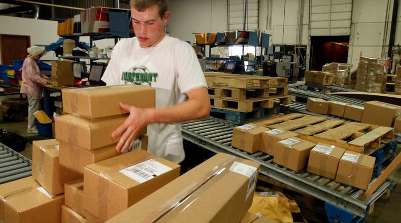 Logan Murphy, a shipping employee for Lastar, packages boxes to be sent throughout North America in this 2010 file photo. Lastar is a manufacturer of low voltage cable and connectivity products. FILE.