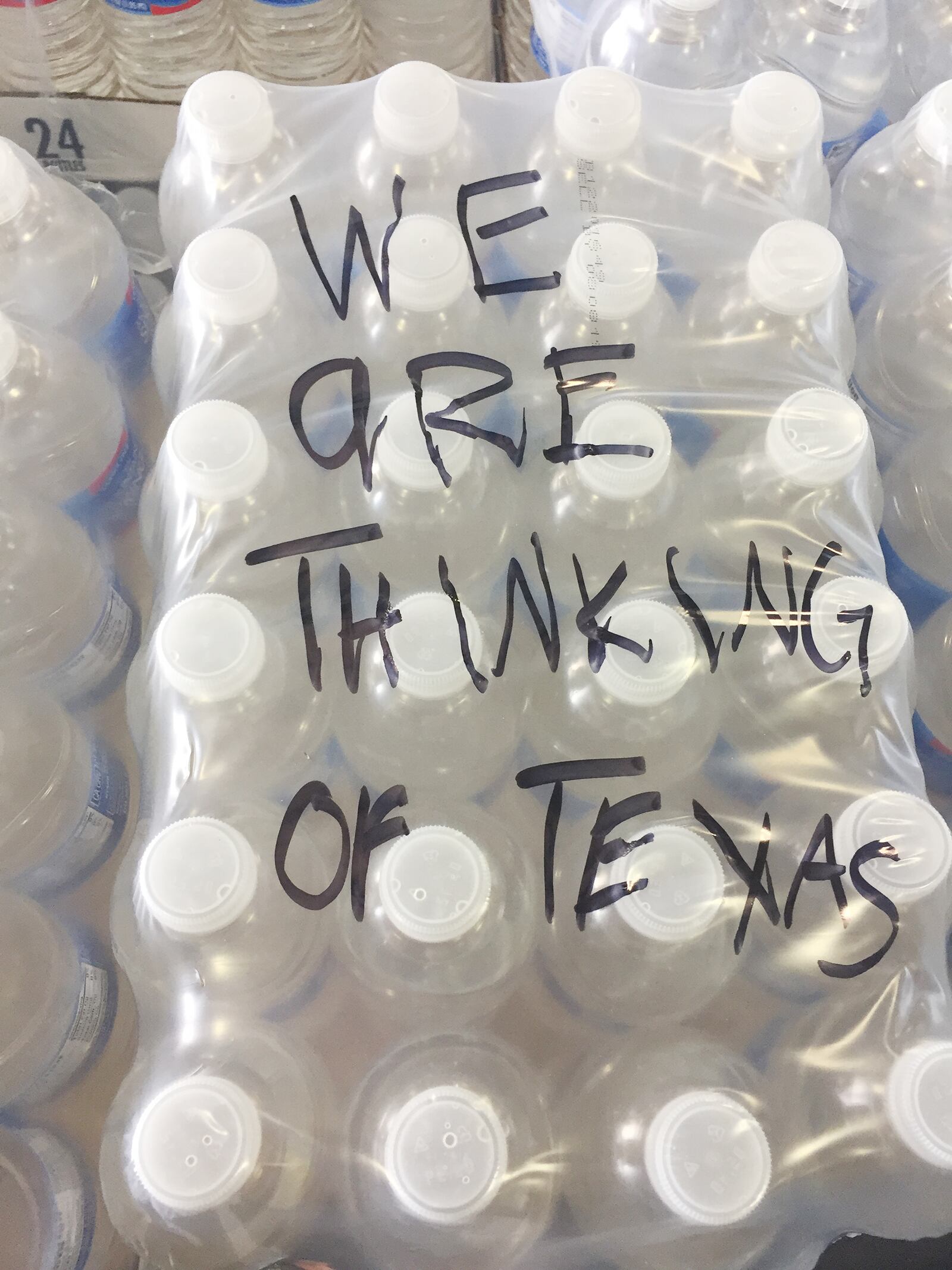 Messages have been left at The Foodbank in Dayton on donated cases of water and pallets bound to victims of Harvey in Texas. SUBMITTED