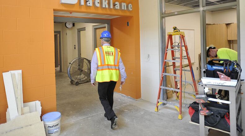 Fairborn City Schools Superintendent Gene Lolli walks through the new Fairborn Primary School. MARSHALL GORBYSTAFF