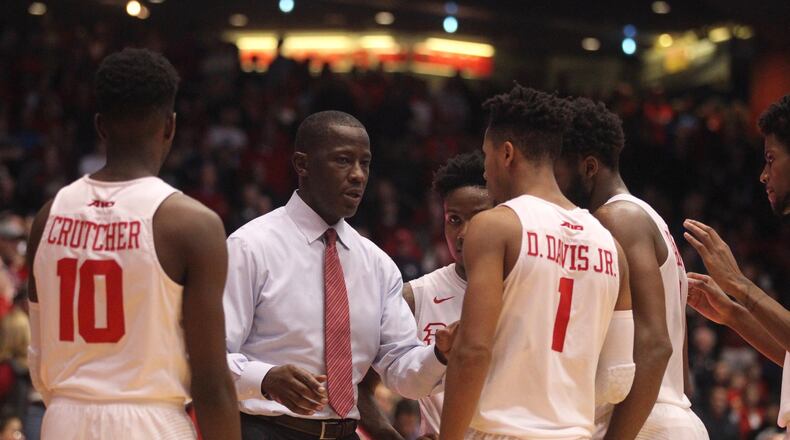 Dayton’s Anthony Grant talks to his players before the final shot against Ball State on Friday, Nov. 10, 2017, at UD Arena. David Jablonski/Staff