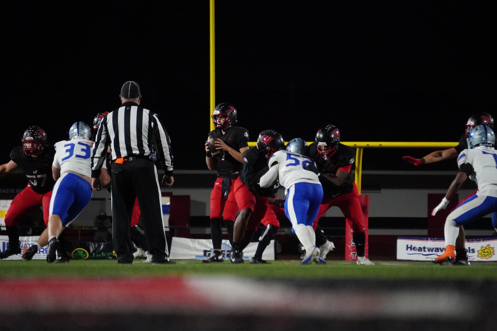 Lakota West quarterback Jackson Smith takes a snap against Hamilton during a Division I, Region 4 playoff game on Friday night at Firebird Stadium. CHRIS VOGT / CONTRIBUTED