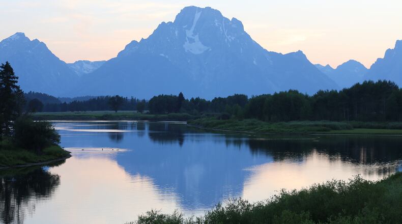 The rising sun illuminates the front of the Teton Mountains, while, as here, the setting sun back lights the peaks that rise abruptly from a valley floor, making them unique among North American mountain ranges. (Dennis Anderson/Minneapolis Star Tribune/TNS)