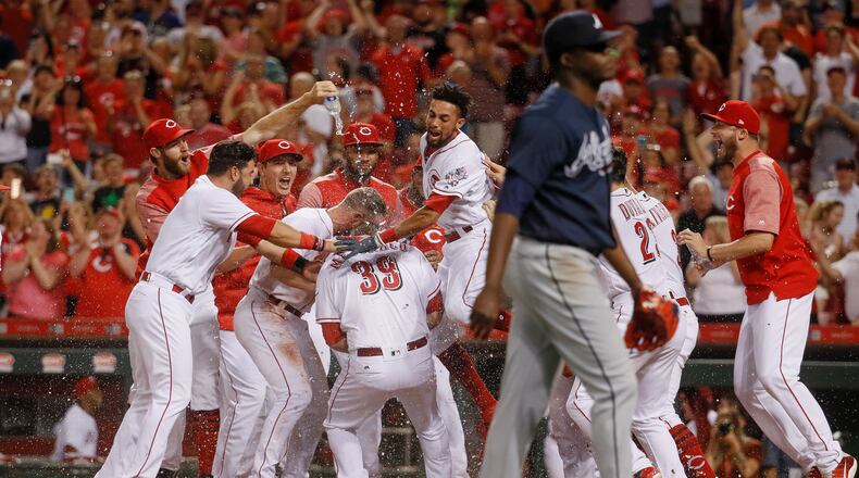 Cincinnati Reds’ Devin Mesoraco (39) celebrates with his teammates after hitting a walk-off home run off Atlanta Braves relief pitcher Jose Ramirez during the 10th inning of a baseball game, Friday, June 2, 2017, in Cincinnati. The Reds won 3-2. (AP Photo/John Minchillo)