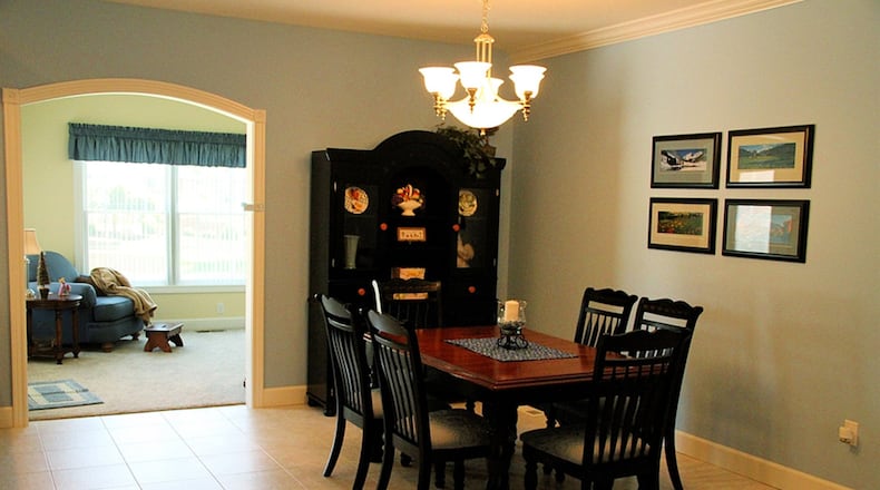 From the dining area an open archway leads to the sunroom, which connects to the 30-by-24-foot patio.