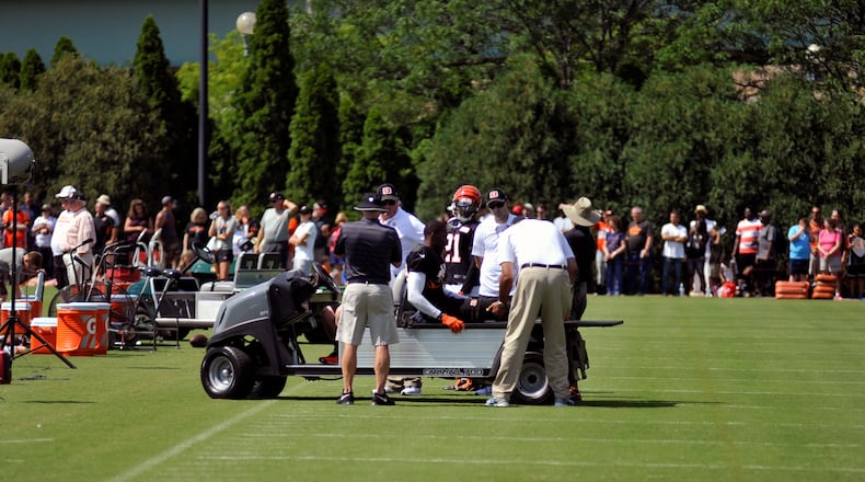 Trainers look at safety George Iloka’s right knee after he injured it during Sunday’s practice. JAY MORRISON/STAFF