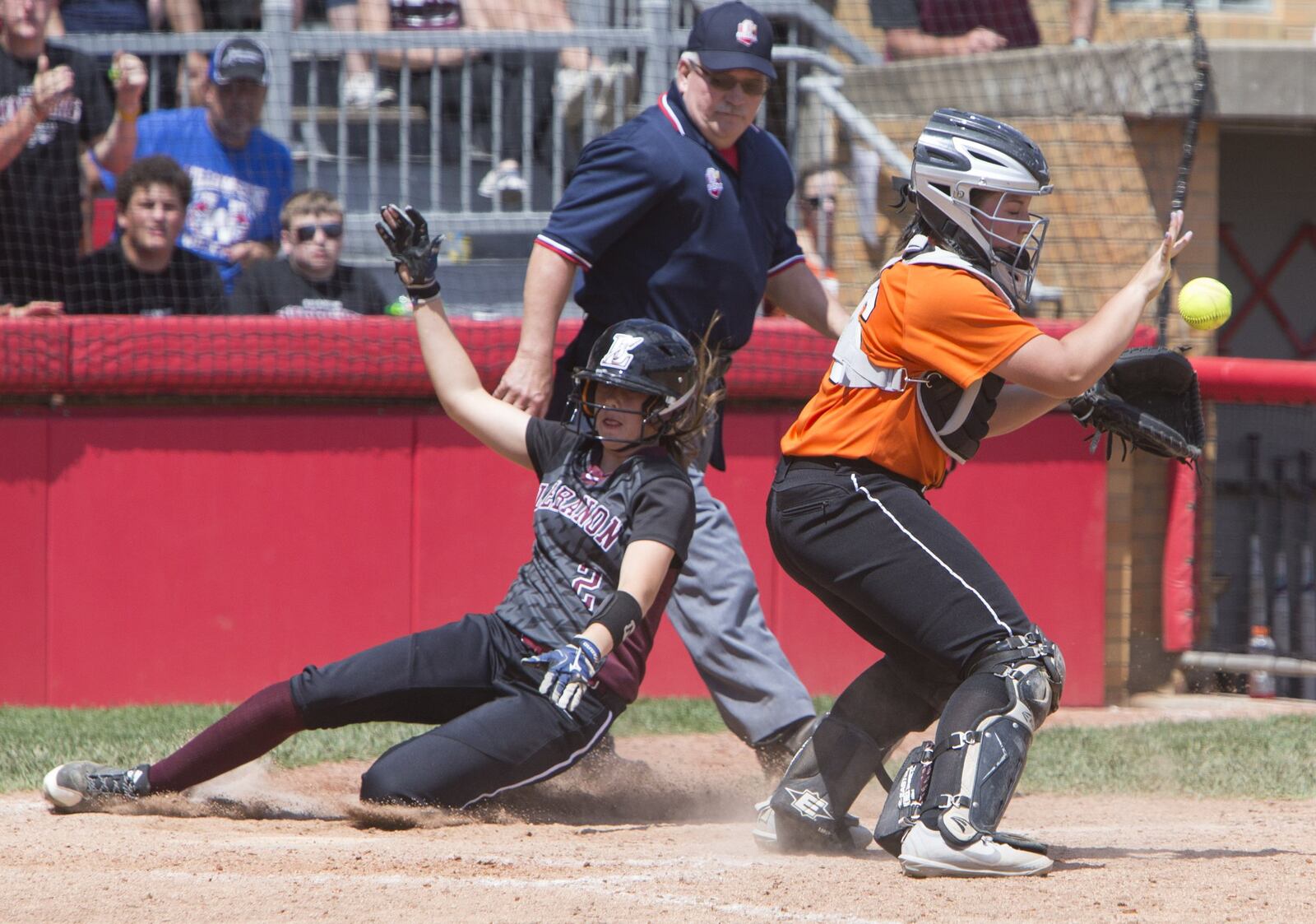 Lebanon’s Kat Frank scores ahead of the throw to North Canton Hoover catcher Laurel DeVoe during Thursday’s Division I state semifinal at Firestone Stadium in Akron. ROBERT ROSSITER/THE CANTON REPOSITORY