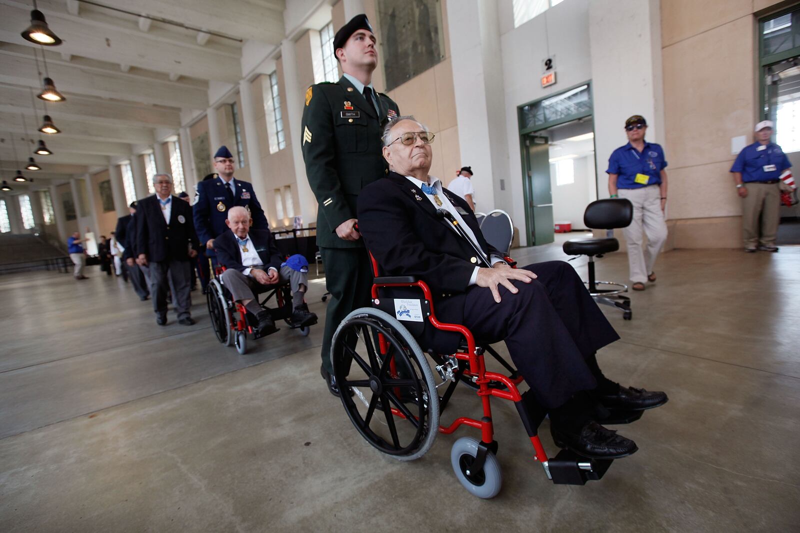CHICAGO - SEPTEMBER 15:  Congressional Medal of Honor recipients Ronald Rosser (R) and Bernard Fisher (L) are pushed out for the start of the opening ceremony for the Medal of Honor Society Convention at Soldier Field September 15, 2009 in Chicago, Illinois. The Medal of Honor is the highest military honor awarded for bravery on the battlefield. There are currently 95 living Medal of Honor Recipients.  (Photo by Scott Olson/Getty Images)