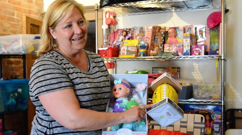 Shelly Calvert of Troy talks about some of the gifts donated for children whose birthdays are celebrated at parties by We Love Birthday Parties. CONTRIBUTED