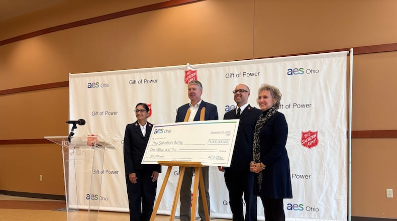 Check presentation time at the Salvation Army Dayton Kroc Center. From left: Salvation Army Maj. Martina Cornell, AES Ohio President Tom Raga, Salvation Army Maj. Paul Cornell and Mary Ann Kabel, AES Ohio director of corporate communications. THOMAS GNAU/STAFF