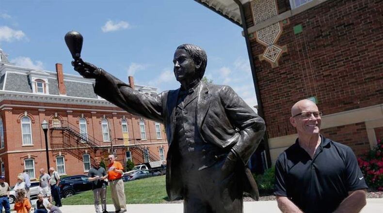 Alan Cottrill, right, smiles as he stands with the 900-pound statue of Thomas Edison that Mr. Cottrill sculpted. The statue replaced one of two representing Ohio in Statuary Hall in the U.S. Capitol. The statue of William Allen, a former Ohio governor and slavery sympathizer, was removed and returned to Ohio. A competition was held to arrive at a symbol more representative of the people of Ohio. KATIE RAUSCH / THE (TOLEDO) BLADE
