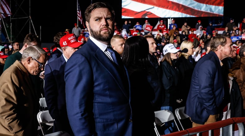 Ohio Senator elect, J.D. Vance listens to former president Donald J. Trump at a rally held November 7, 2022 at the Dayton International Airport. JIM NOELKER/STAFF