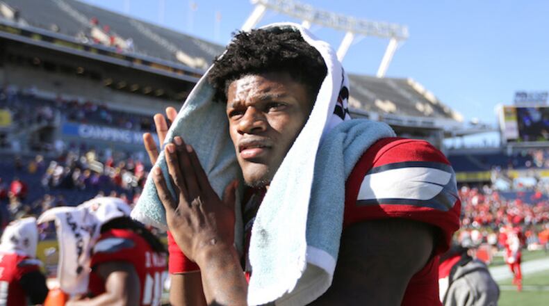 Louisville quarterback and Heisman trophy winner Lamar Jackson leaves the field after a 29-9 loss against LSU in the Buffalo Wild Wings Citrus Bowl at Camping World Stadium in Orlando, Fla., on Saturday, Dec. 31, 2016. (Joe Burbank/Orlando Sentinel/TNS)