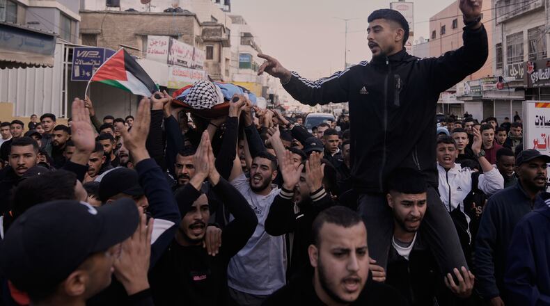 Mourners carry the body of the Palestinian Hassan Ahmed Jamil Moussa,19, who, according to health authorities, was killed during an Israeli raid last night, during his funeral in the Askar camp near the West Bank city of Nablus, Sunday, Nov. 16, 2025. (AP Photo/Majdi Mohammed)