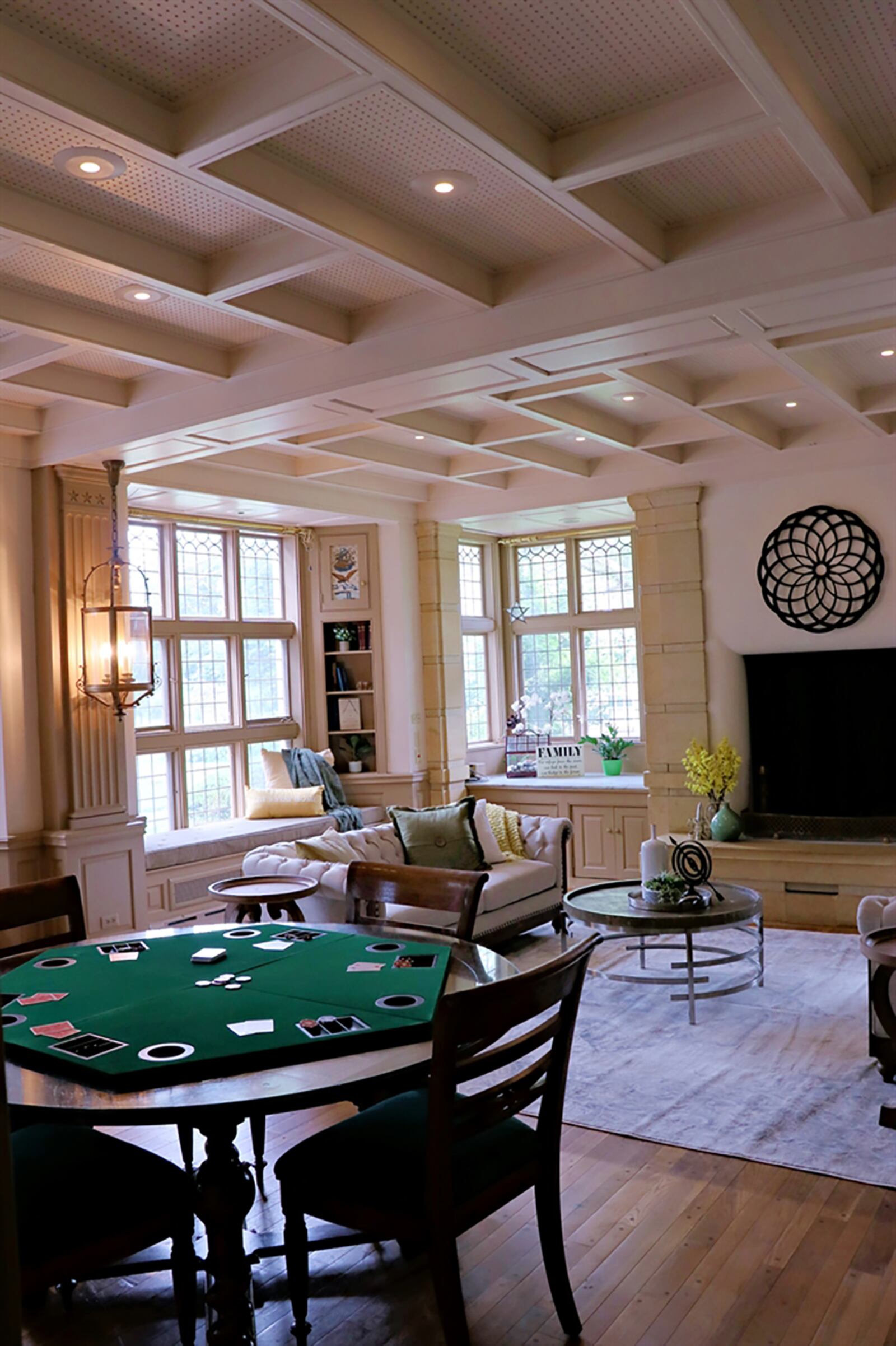 Coffered ceilings in the great room hide the filtered-air system and complement accent beams that form the window seats. A massive limestone wood-burning fireplace has a detailed mantel and raised hearth. Hidden storage and wood-bins accessible from the outside surround the fireplace. CONTRIBUTED PHOTO BY KATHY TYLER