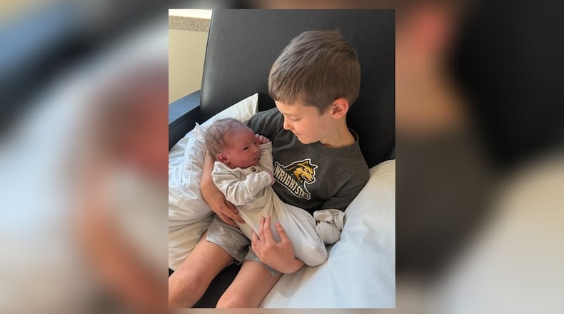 Wright State University men’s basketball coach Clint Sargent and his wife Jill had a baby on Monday morning ahead of the Raiders' 63-57 victory over Ohio University at UD Arena later that night. In this photo, Sargent’s son Jordy holds his baby brother Booker David Sargent on Monday at Kettering Hospital. CONTRIBUTED PHOTO