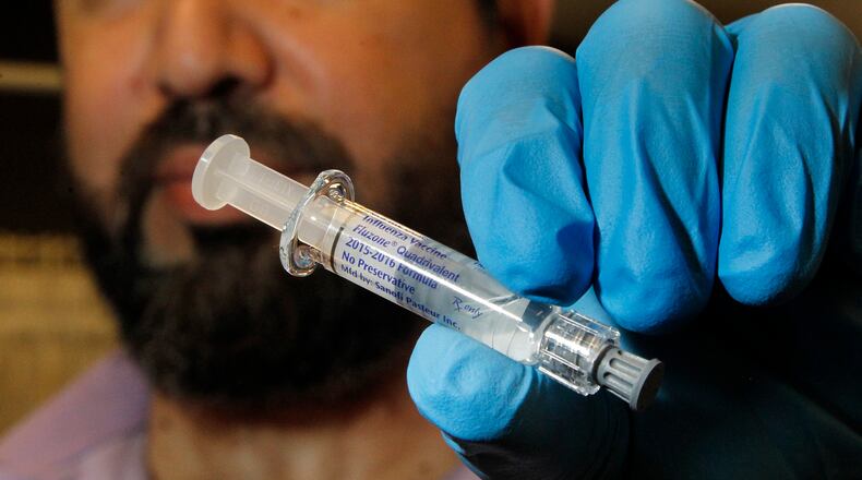 Dr. Kindy Ghussin, the owner of Heartland Pharmacy in Kettering, is ready to administer flu shots. LISA POWELL / STAFF