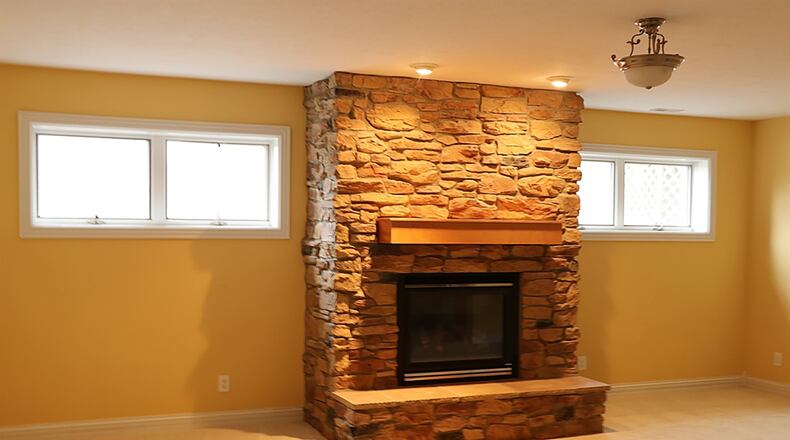 The lower level has been finished into a recreation room with a stone fireplace and kitchenette area, a media room, an exercise room and 2 bedrooms with above-ground windows and a full bathroom.