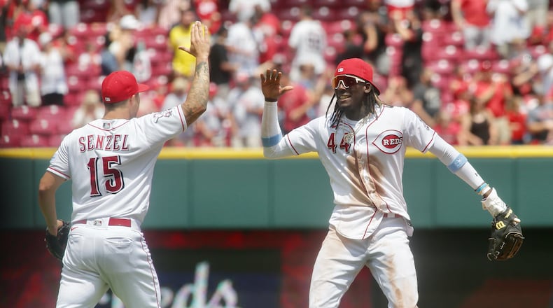 The Reds' Nick Senzel, left, and Elly De La Cruz elebrate a victory against the Colorado Rockies on Wednesday, June 21, 2023, at Great American Ball Park in Cincinnati. David Jablonski/Staff