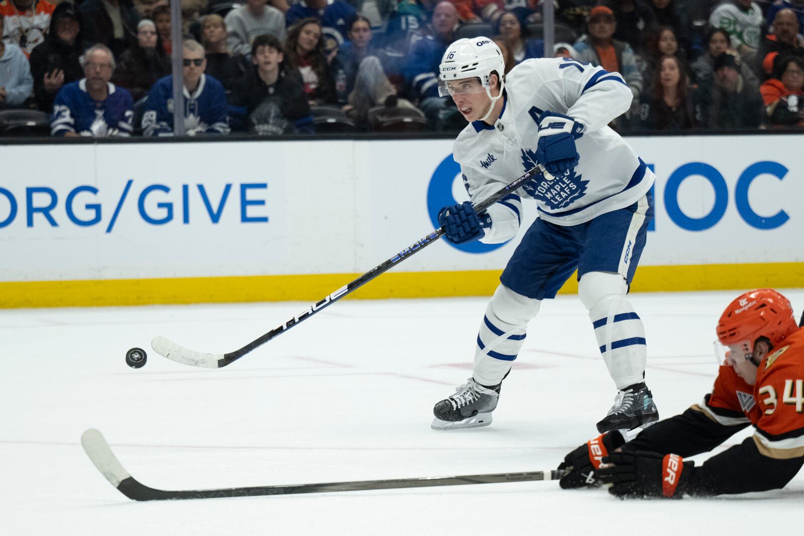 FILE - Toronto Maple Leafs right wing Mitch Marner (16) shoots past Anaheim Ducks defenseman Pavel Mintyukov (34) during the second period of an NHL hockey game, March 30, 2025, in Anaheim, Calif. (AP Photo/Kyusung Gong, file)