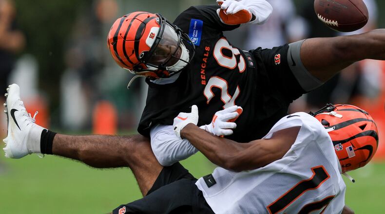 Cincinnati Bengals' Kendric Pryor, bottom, attempts a catch against Cam Taylor-Britt during the NFL football team's training camp in Cincinnati, Wednesday, July 27, 2022. (AP Photo/Aaron Doster)