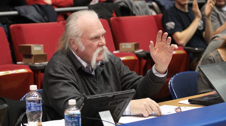 Tom Archdeacon waves to the crowd after being honored during a Dayton game against Rhode Island on Friday, Jan. 6, 2017, at UD Arena. David Jablonski/Staff