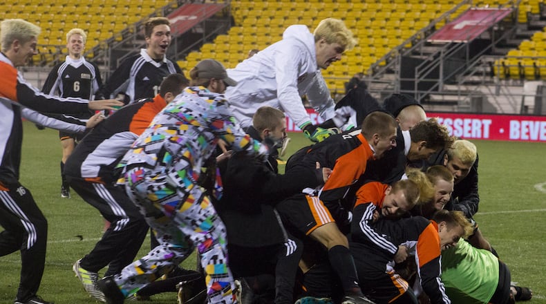 Beavercreek celebrates its first boys state soccer championship seconds after Ryan Bernt’s winning goal. JEFF GILBERT/CONTRIBUTED