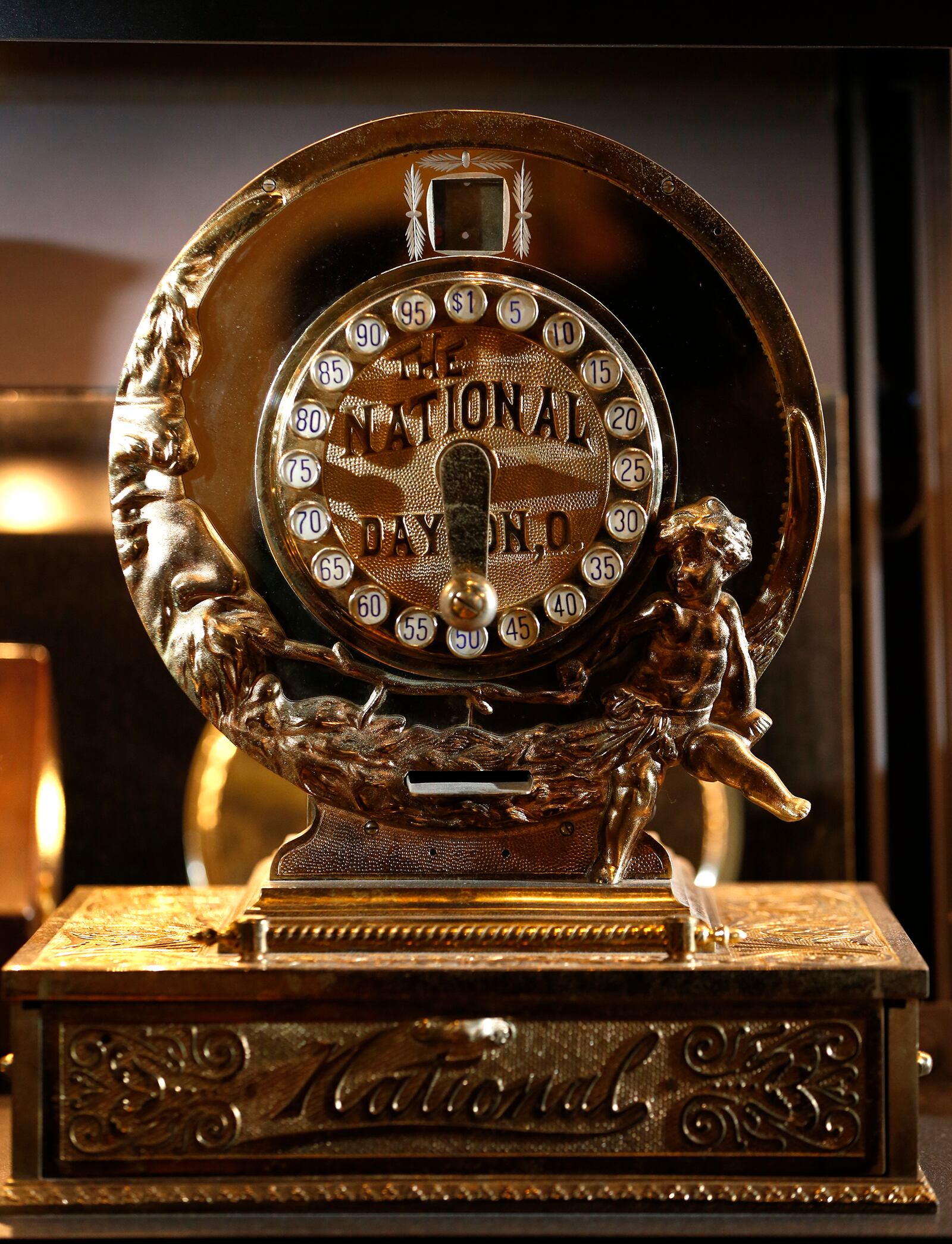 The Man in the Moon and a cherub flank the face of the Model 111 cash register made by NCR for an exhibition at the 1893 World's Fair in Chicago. The register has a check printer in the face where a check or receipt could be inserted in the slot and the sale amount would be printed on the check. LISA POWELL / STAFF