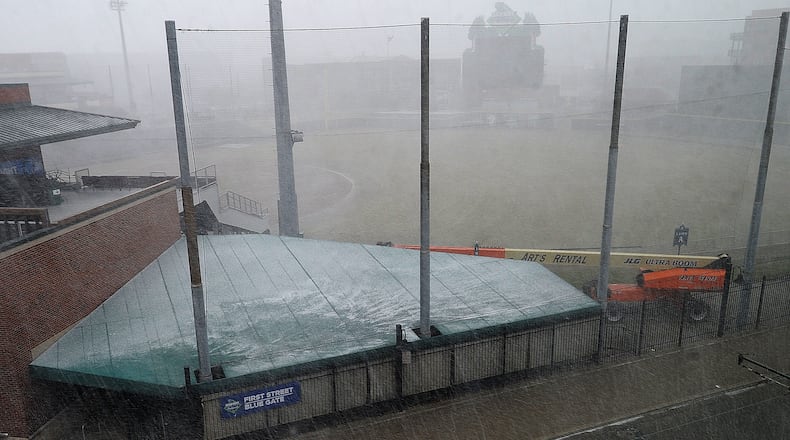 Scattered, heavy snow showers caused a whiteout at Day Air Ballpark in Dayton on March 13, 2023. MARSHALL GORBY\STAFF