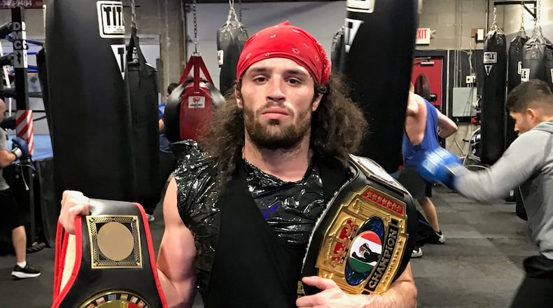 Middleweight Andrew Zammit with two of the amateur championship belts he’s won in a 17-3 career that is highlighted by several dramatic knockout victories. Tom Archdeacon/CONTRIBUTED