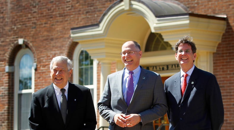 Brother Raymond Fitz, president of the University of Dayton from 1979-2002, Eric Spina, the latest university president and Daniel Curran, the former president (left to right) took part in a university photo shoot in front of historic St. Mary’s Hall to commemorate the moment in UD’s history. LISA POWELL / STAFF