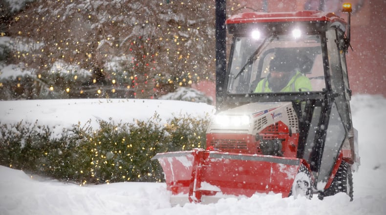 A city worker removes snow from the sidewalks on Fountain Avenue on Monday, Jan. 6, 2025 after a heavy snowfall overnight. MARSHALL GORBY/STAFF