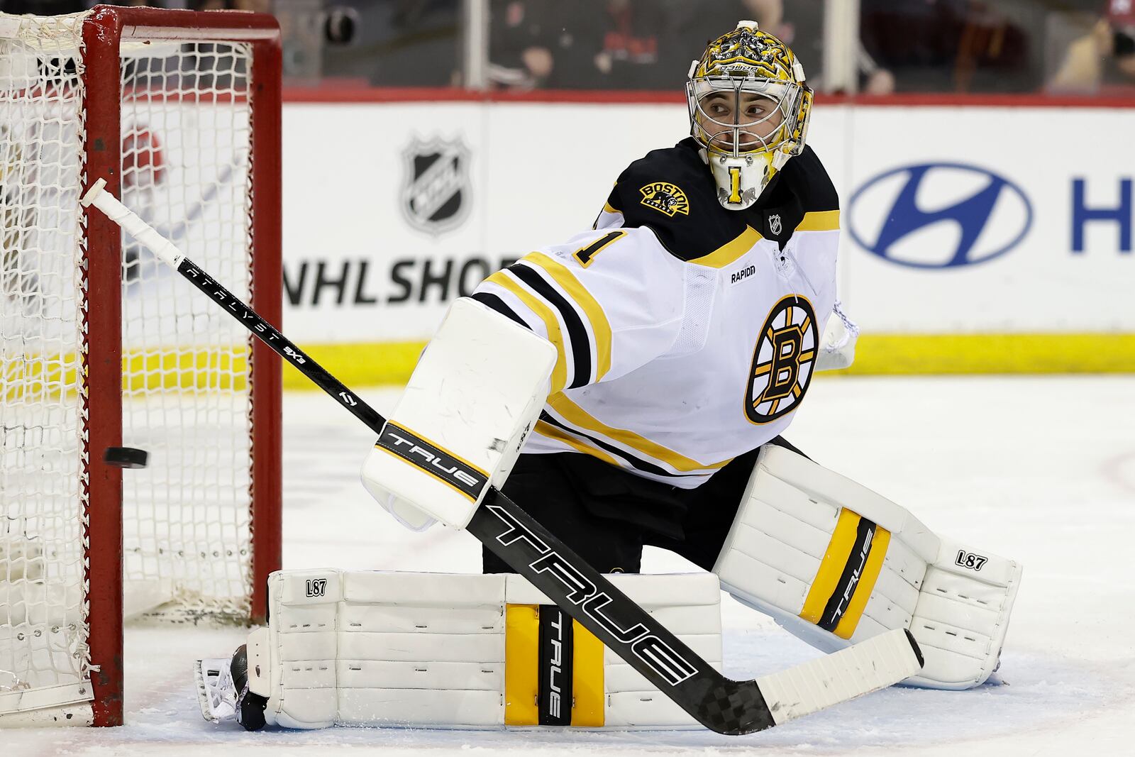 Boston Bruins goaltender Jeremy Swayman watches a shot go wide of the net in the second period of an NHL hockey game against the New Jersey Devils, Tuesday, April 8, 2025, in Newark, N.J. (AP Photo/Adam Hunger)