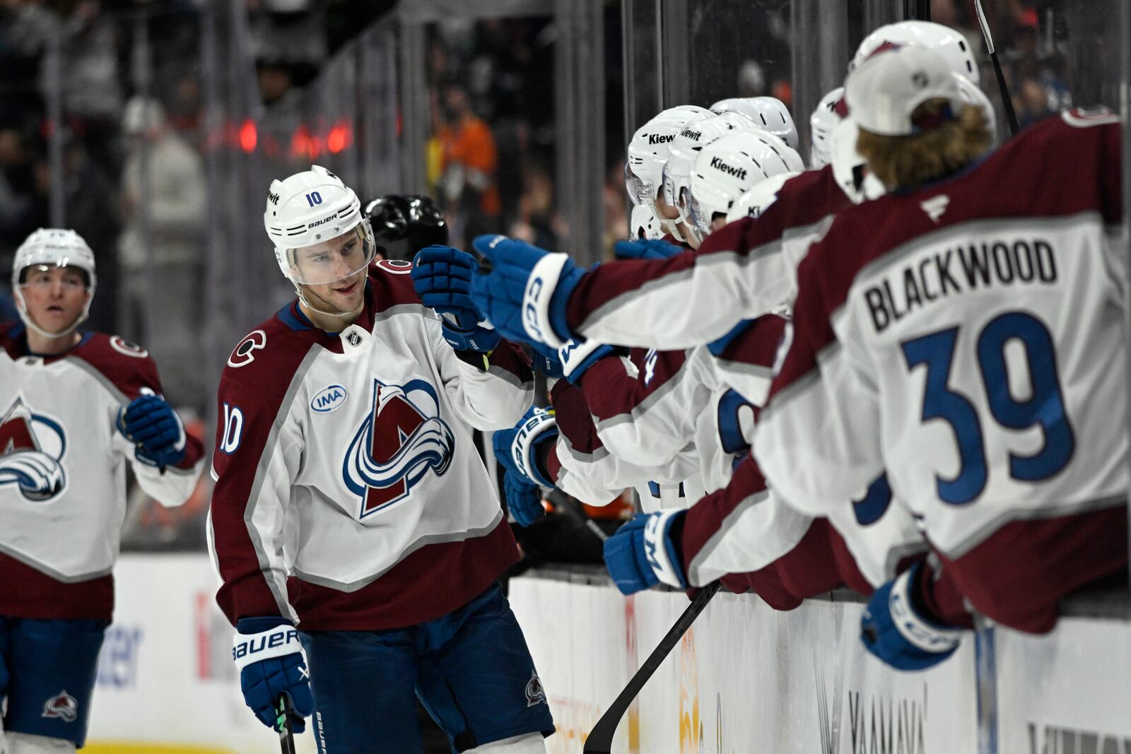 Colorado Avalanche center Charlie Coyle (10) celebrates with teammates after scoring against the Anaheim Ducks during the third period of an NHL hockey game in Anaheim, Calif., Sunday, April 13, 2025. (AP Photo/Alex Gallardo)